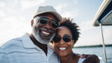 Fototapeta Uliczki - Smiling middle aged black couple enjoying leisure sailboat ride in summer