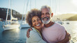Smiling middle aged mixed race couple enjoying sailboat ride on summer day