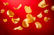 © Emre Akkoyun - Potato chips flying on red background