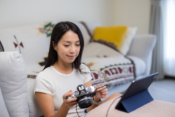 Wall Mural - Woman use digital camera connect with tablet computer at home