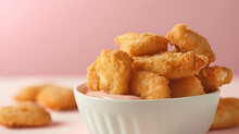 Plate Of Tasty Chicken Or Fish Nuggets On Plain Pink Background. Chicken Nugget Food Banner With Copy Space.