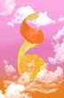 Orange tangerine in the pink sky, abstraction, collage, perfect for poster or advertisement. Photo mixed with graphics. 