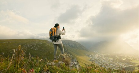 Wall Mural - woman, trekking and video recording on mountains in adventure, wellness and health with nature and c