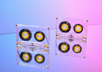 Two transparent audio cassettes. Idea of disco and party.