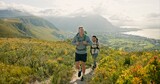 Couple of friends walking, hiking on mountain and travel for fitness, adventure or journey in nature for wellness. Young people trekking with backpack on a path or green hill for cardio and health