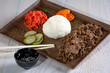 Japanese cuisine - Yakiniku with shredded entrecote, pickled cucumber and yakiniku sauce