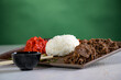 Japanese cuisine - Yakiniku with shredded entrecote, rise, pickled cucumber and yakiniku sauce 8green background)