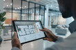 close-up of an interior architect presenting design proposals to clients using digital renderings and interactive floor plans on a tablet device in a sleek office boardroom, photo