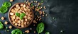 © TheWaterMeloonProjec - A dish made with ingredients like chickpeas and spinach, placed on a black table. The dish features a mixture of terrestrial plant produce, highlighting the cuisine's use of natural elements.