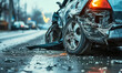 Close-up of a wrecked car's damaged front side after a severe road collision, with debris scattered on the asphalt in the aftermath of an accident