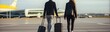 Back view of young couple with suitcases walking in airport terminal. Travel and business concept. Travel and tourism concept with copy space. Travel concept with copy space. 