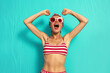 © wolfhound911 - Photo woman fist up scream yes swimmer ocean distance win wear red striped set shorts isolated vivid color background