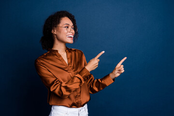 Wall Mural - Photo of adorable excited lady wear silk brown shirt spectacles looking showing two fingers empty space isolated blue color background