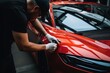 © Yuliia - Professional unrecognizable Caucasian specialist male man guy worker master wrapping installing protective film vinyl foil new red sport car automobile transport paint protection indoors salon service