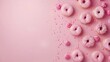Pink Glazed Donuts with Sprinkles on Light Pink Background.