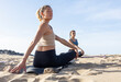 © ADDICTIVE STOCK - Beach Yoga Class at Sunset in Easy Pose