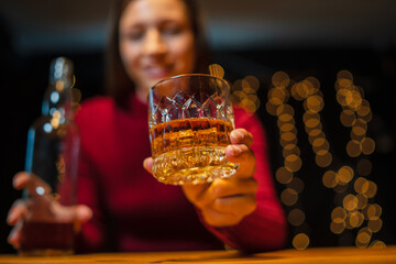 Wall Mural - Barwoman pouring whiskey whiskey glass..