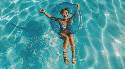 Wall Mural - Smiling exited young woman in swimming pool floating on swimming ring