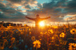 Joyful man raising his hands during sunset embrace in a field of wildflowers with radiant sky backdrop. View from the back