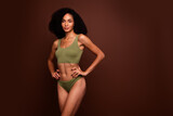 Fototapeta Panele - Studio no retouch photo of positive confident lady dressed lingerie enjoying perfect body empty space isolated brown color background