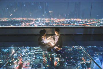 Couple sitting and looking at the city view