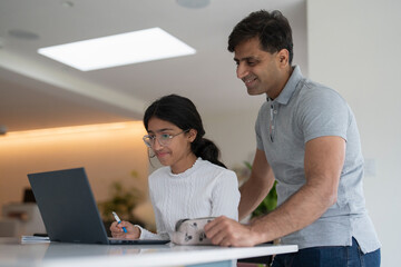 Wall Mural - Father helping daughter doing homework