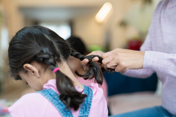 Wall Mural - Mother doing daughter braids