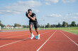 © Cultura Creative - Athlete sprinting off at running track