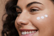 © Cultura Creative - Close-up of young woman applying face cream