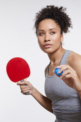 Wall Mural - Studio portrait of woman with table tennis racket and ball