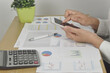 © aorphoto - businesswoman analysis financial graphs and charts report on desk in office.