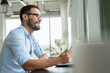 © Cultura Creative - Businessman with laptop working in modern office