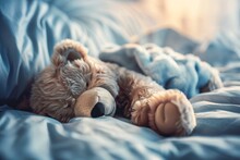 A Stuffed Teddy Bear Lays Peacefully On A Bed, Surrounded By Soft Blankets And Pillows, Ready For A Cozy Nap