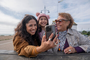 Poster - Grandmother, mother and daughter taking selfie with smart phone