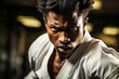 © Surachetsh - a martial arts practitioner in a karate class, his visage exuding determination and strength as he focuses on his training.