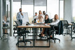 © standret - By the table and with whiteboard. Group of office workers are together indoors