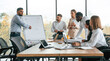 © standret - Business strategy on the whiteboard. Group of office workers are together indoors