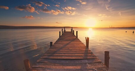 Wall Mural - Scenic sunset over the old fishing wooden pier and sea lake ripple water, nature landscape relaxation video