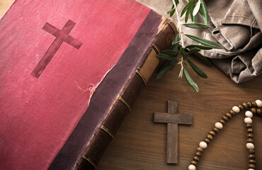 Wall Mural - Bible on wooden table with cross olive leaves and fabric