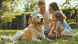 Smiling father, mother and daughter petting and playing with purebred Labrador dog. The sun is shining on an idyllic happy family with a cute dog having fun in the backyard of an idyllic country house