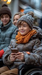 Poster - A boy in a wheelchair looking at a cell phone