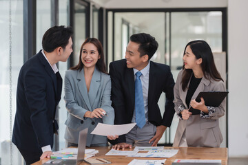 Poster - Young motivated Asian business team discussing oh business strategy in the modern meeting room.