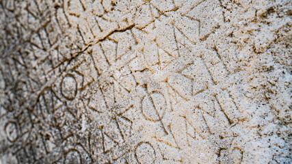 Wall Mural - Close-up  background of ancient Greek writings on the ruins of an ancient city