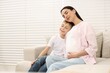 © New Africa - Pregnant woman with her son at home, space for text