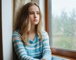 © orelphoto - Beautiful caucasian sad teenage girl sits on windowsill