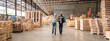 © chokniti - Man and woman workers with clipboard discussing working and checking stock inventory wood plank material for making wooden pallet products at warehouse industrial factory, woodwork production