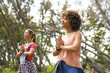 © Wavebreak Media - Two women practice yoga in a serene forest setting