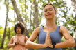 © Wavebreak Media - Young Caucasian woman with her eyes closed, hands in prayer position, practicing yoga outdoors