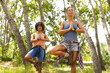 © Wavebreak Media - Young Caucasian woman and biracial woman practice yoga outdoors