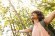 © Wavebreak Media - Young biracial woman with curly hair enjoys nature, arms outstretched and eyes closed, with copy spa